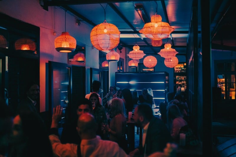 Networking at the bar under lanterns